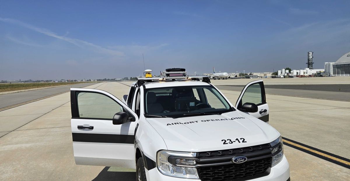 An airport-operations truck fitted with the LAIRA rig on an active airfield at San Bernardino International Airport.