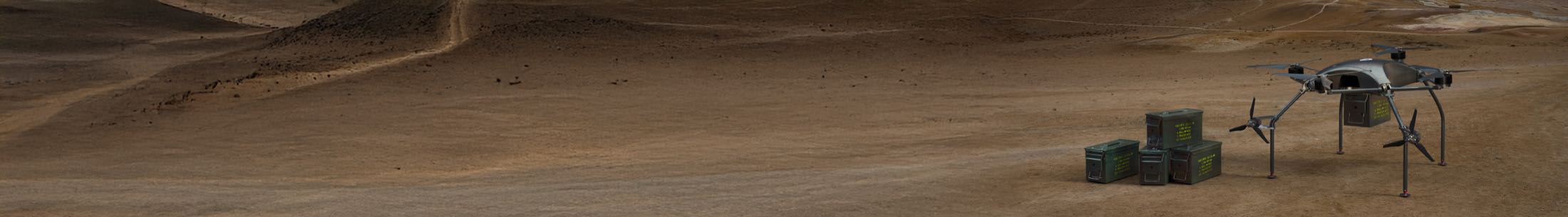 The Gabriel aircraft delivering supply crates on austere desert terrain.